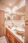 2nd bathroom with marble countertop and his and her sinks